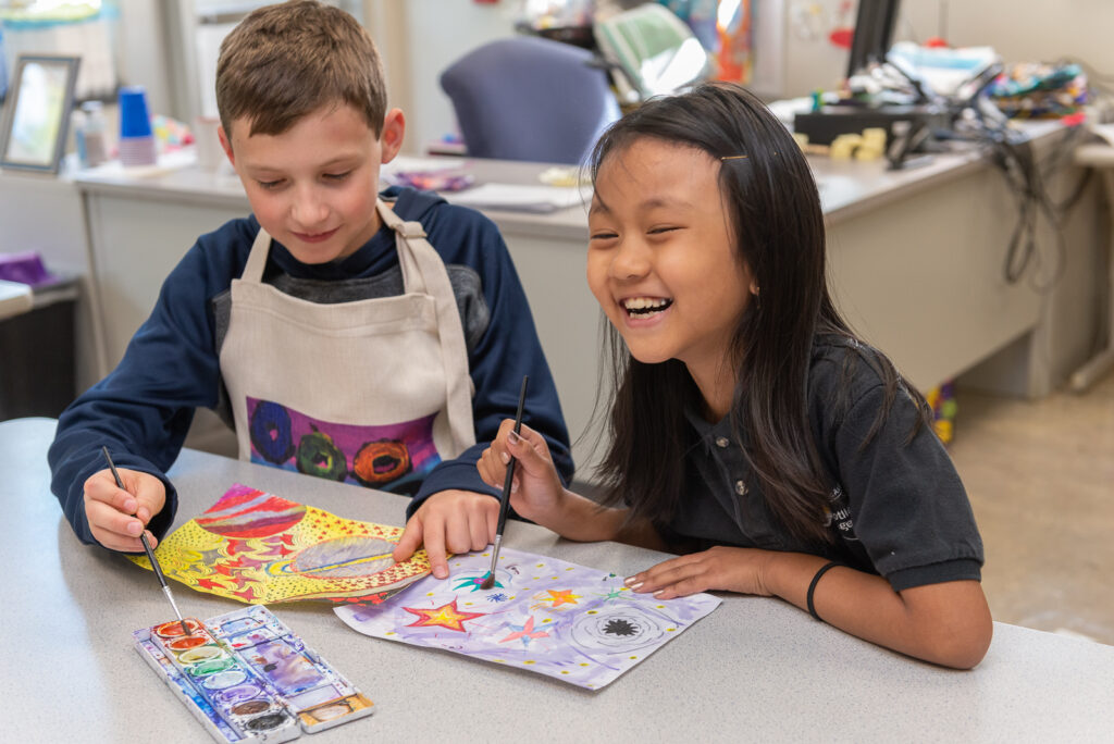 Contact Art to Remember about an Art Fundraiser for Schools image shows boys and girl working on art at table