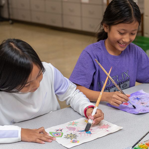 Work with Art to Remember on an Art Fundraiser for Schools image shows two kids painting